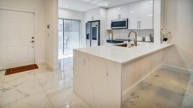 6320 Wedgewood Ter Unit 6320, Tamarac, FL 33321 - kitchen featuring appliances with stainless steel finishes, baseboards, white cabinetry, and marble finish floor