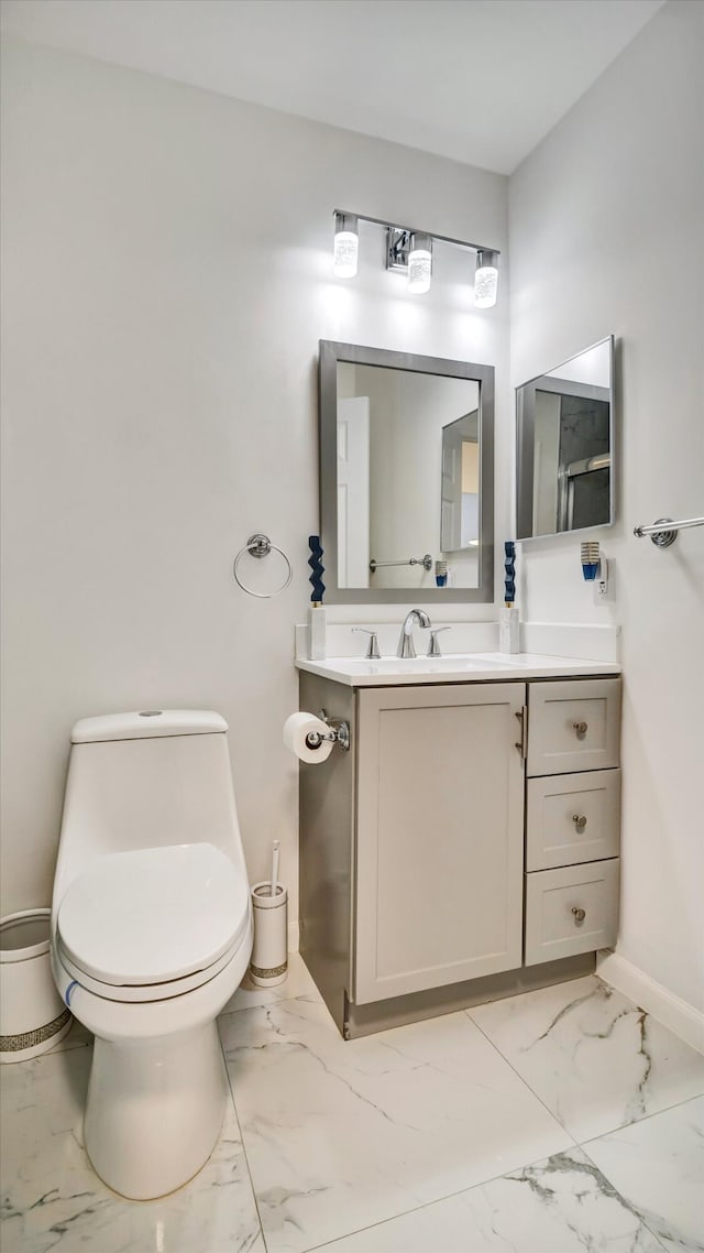 6320 Wedgewood Ter Unit 6320, Tamarac, FL 33321 - half bathroom with baseboards, vanity, toilet, and marble finish floor
