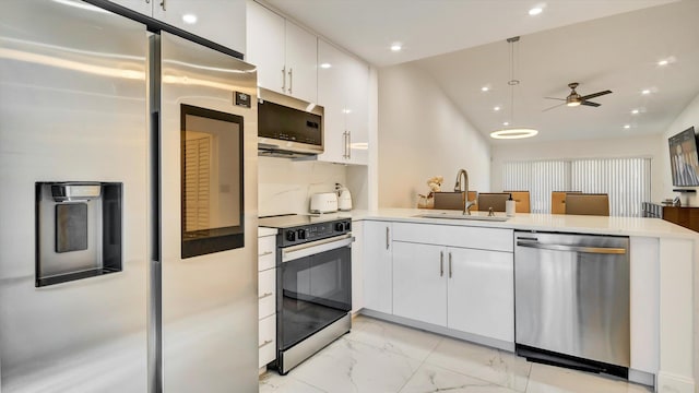 6320 Wedgewood Ter Unit 6320, Tamarac, FL 33321 - kitchen featuring a ceiling fan, appliances with stainless steel finishes, a sink, a peninsula, and marble finish floor