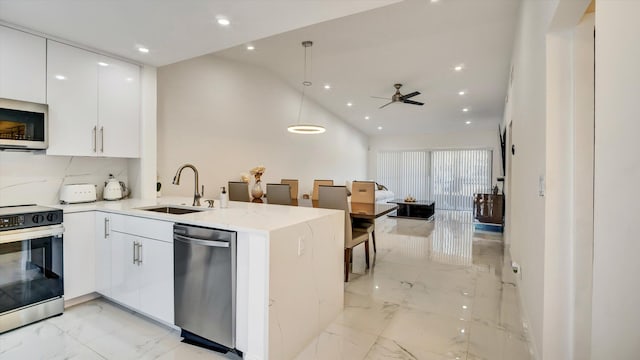 6320 Wedgewood Ter Unit 6320, Tamarac, FL 33321 - kitchen featuring marble finish floor, a peninsula, white cabinets, a sink, and stainless steel appliances