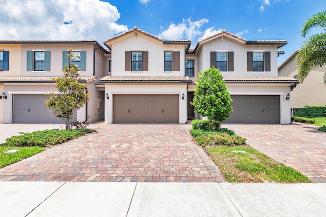 8243 Cinch Way, Lake Worth, FL 33467 - view of front of home with an attached garage, stucco siding, and decorative driveway