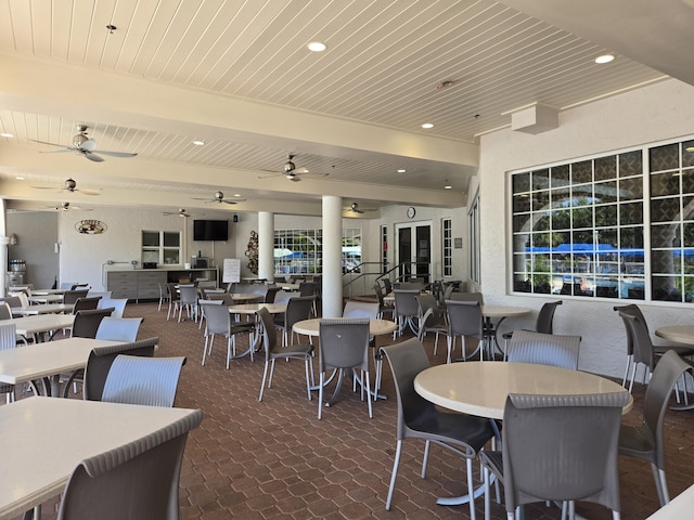 dining area featuring ceiling fan, wooden ceiling, and a healthy amount of sunlight