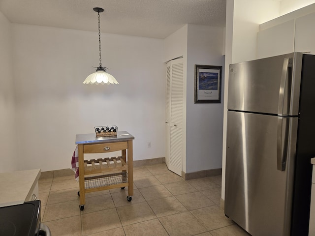 5135 Floria Dr Unit G, Boynton Beach, FL 33437 - dining area featuring light tile patterned floors, baseboards, and a textured ceiling