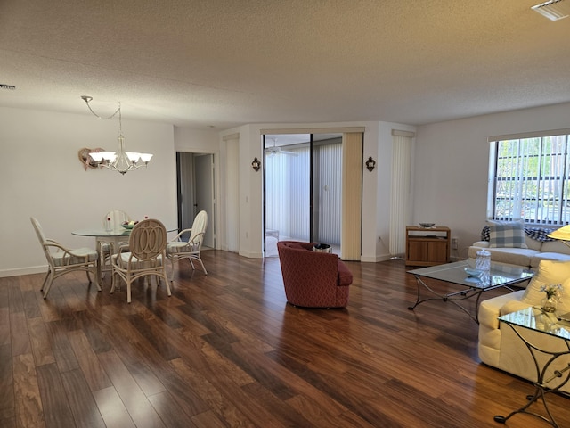 5135 Floria Dr Unit G, Boynton Beach, FL 33437 - dining space with a chandelier, dark wood-style floors, a textured ceiling, and baseboards