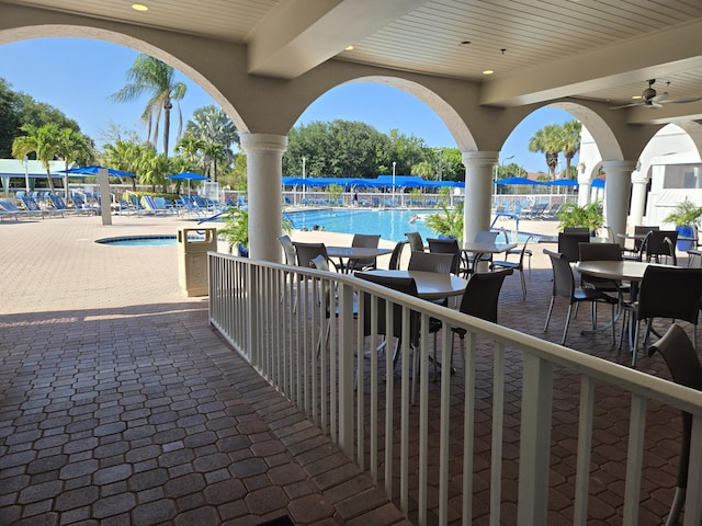 view of patio / terrace featuring a ceiling fan and a community pool