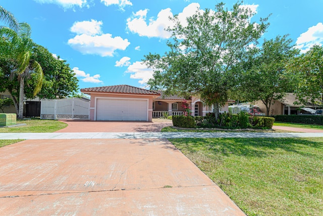 22031 SW 127th Ave, Miami, FL 33170 - mediterranean / spanish house with stucco siding, a tiled roof, a gate, concrete driveway, and a garage