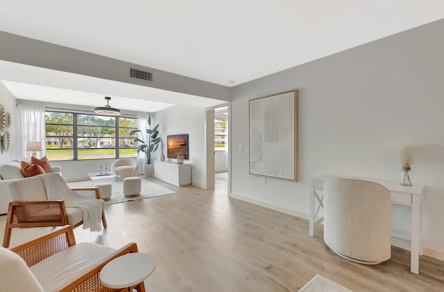 6049 Balboa Cir Unit 106, Boca Raton, FL 33433 - living area with visible vents, light wood-style floors, and baseboards
