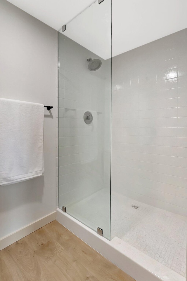 6049 Balboa Cir Unit 106, Boca Raton, FL 33433 - full bathroom featuring a walk in shower, baseboards, and wood finished floors