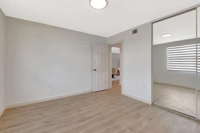 6049 Balboa Cir Unit 106, Boca Raton, FL 33433 - unfurnished bedroom featuring visible vents, light wood finished floors, baseboards, and a closet