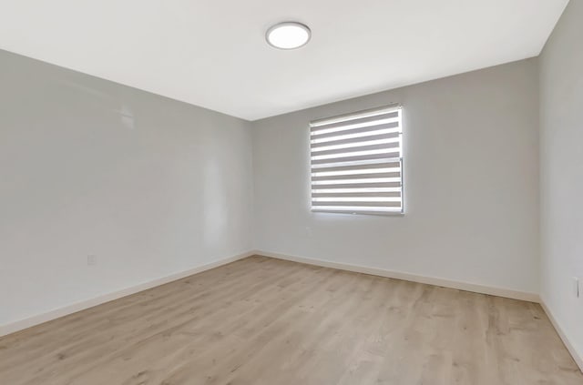 6049 Balboa Cir Unit 106, Boca Raton, FL 33433 - spare room with baseboards and light wood-type flooring