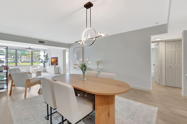 6049 Balboa Cir Unit 106, Boca Raton, FL 33433 - dining room with baseboards, light wood-type flooring, a chandelier, and visible vents