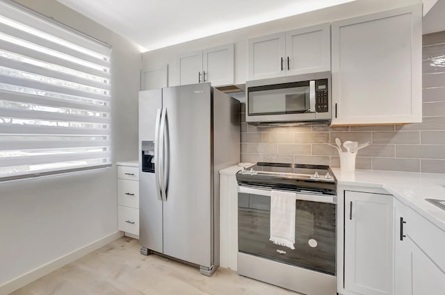 6049 Balboa Cir Unit 106, Boca Raton, FL 33433 - kitchen with light countertops, decorative backsplash, plenty of natural light, and stainless steel appliances