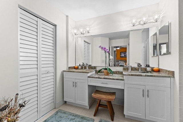 full bathroom with a closet, tile patterned flooring, and vanity