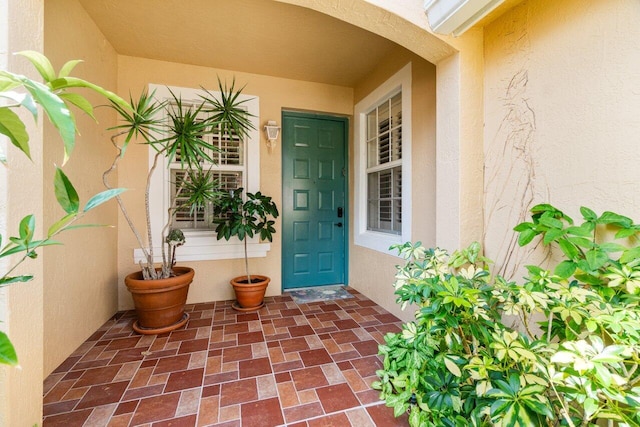 entrance to property with stucco siding