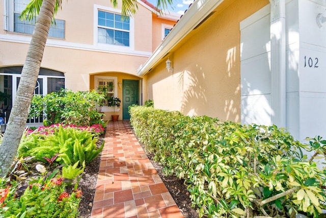 property entrance with stucco siding