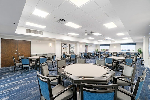 interior space with visible vents, a drop ceiling, and carpet