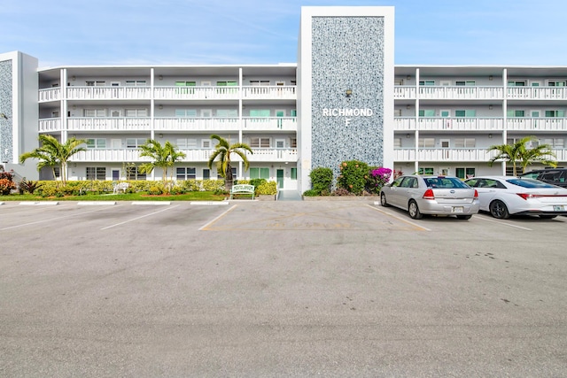 view of building exterior featuring uncovered parking