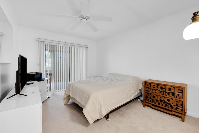 bedroom with a ceiling fan and light carpet