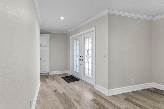 foyer with crown molding, light wood-style flooring, baseboards, and french doors