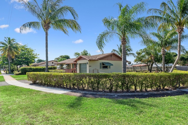 view of property exterior with fence, stucco siding, and a yard