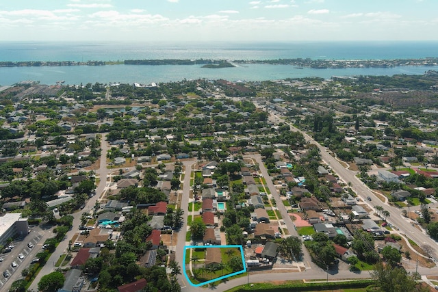 birds eye view of property featuring a residential view and a water view