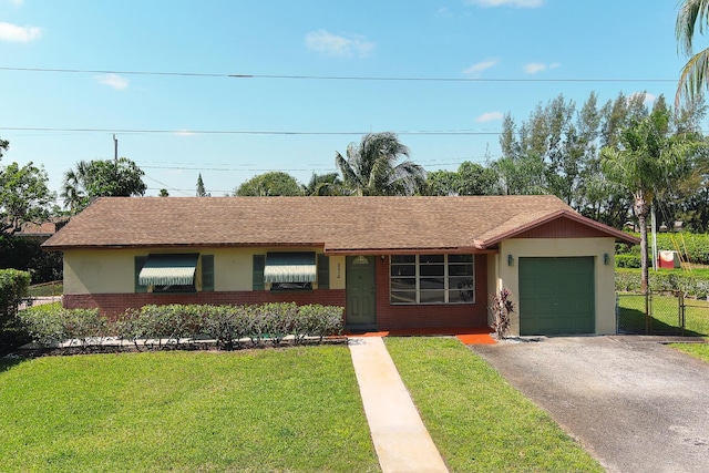 ranch-style house with driveway, a front yard, a garage, brick siding, and stucco siding