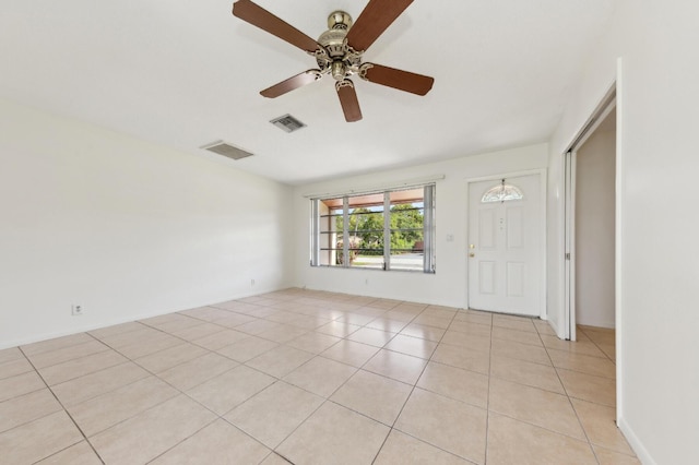 unfurnished room featuring ceiling fan, light tile patterned flooring, and visible vents