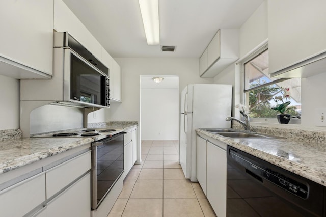 kitchen with visible vents, freestanding refrigerator, electric range, white cabinetry, and dishwasher