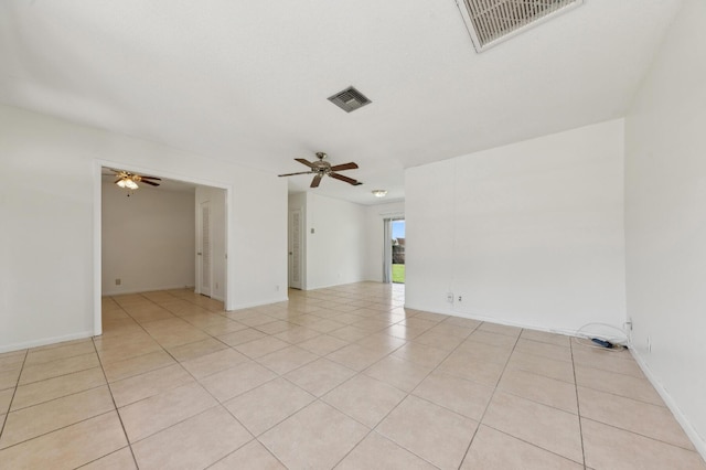 unfurnished room featuring a ceiling fan, light tile patterned flooring, and visible vents