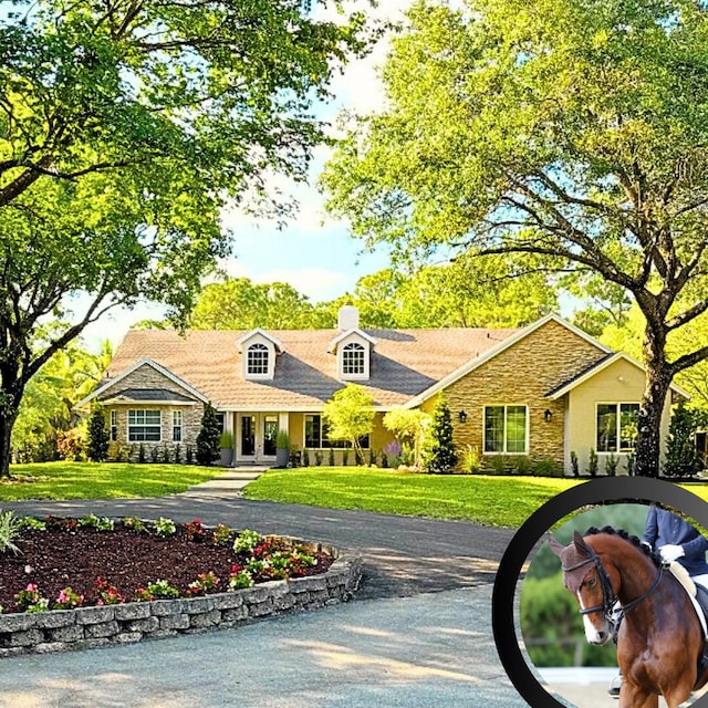 17225 Mare Ln, Loxahatchee, FL 33470 - view of front of home with stone siding and a front yard