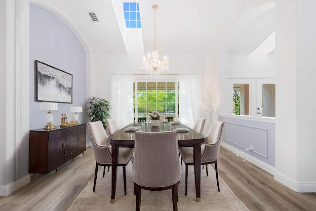 17225 Mare Ln, Loxahatchee, FL 33470 - dining area featuring a chandelier, light wood-style flooring, healthy amount of natural light, and baseboards