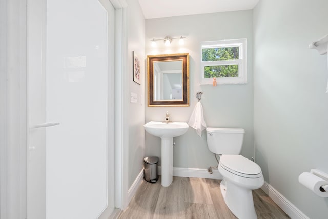 17225 Mare Ln, Loxahatchee, FL 33470 - bathroom with toilet, wood finished floors, and baseboards