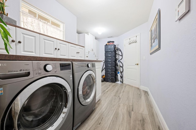 17225 Mare Ln, Loxahatchee, FL 33470 - washroom with separate washer and dryer, cabinet space, baseboards, and light wood-type flooring