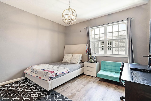 503 Vision Ct, Palm Beach Gardens, FL 33418 - bedroom with an inviting chandelier, baseboards, and wood finished floors