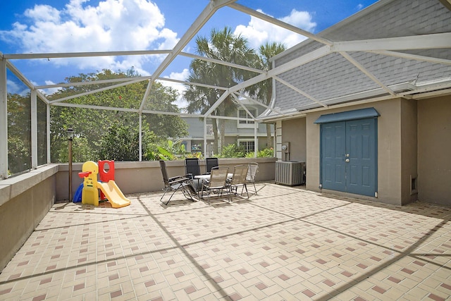 503 Vision Ct, Palm Beach Gardens, FL 33418 - view of patio / terrace featuring outdoor dining area, central AC unit, and a lanai