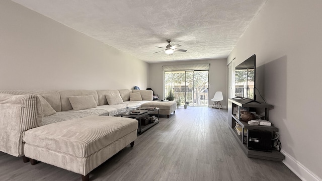 2925 SW 22nd Ave Unit 2030, Delray Beach, FL 33445 - living room with wood finished floors, ceiling fan, baseboards, and a textured ceiling