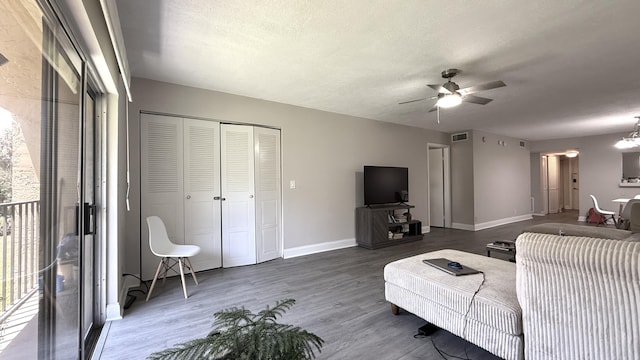 2925 SW 22nd Ave Unit 2030, Delray Beach, FL 33445 - living room with ceiling fan, wood finished floors, baseboards, a textured ceiling, and a chandelier