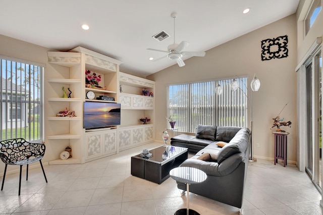 living area with visible vents, ceiling fan, light tile patterned floors, and a wealth of natural light