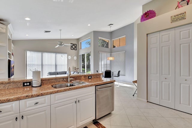 kitchen with a ceiling fan, visible vents, stainless steel dishwasher, a sink, and white cabinets