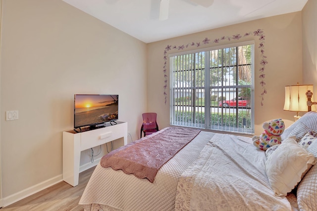 bedroom with baseboards, ceiling fan, and wood finished floors