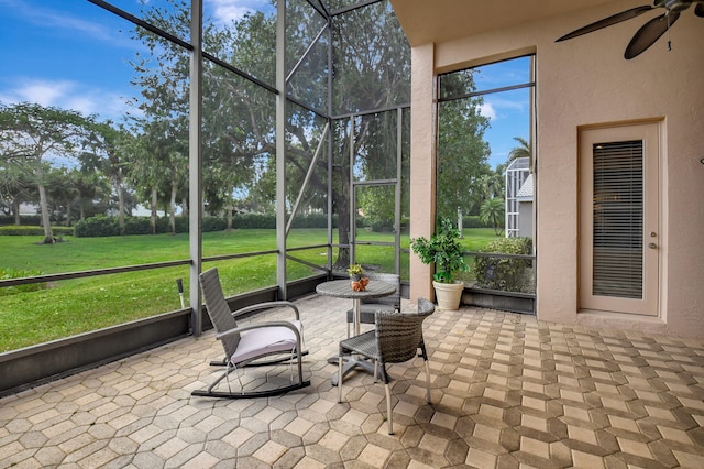 sunroom featuring a ceiling fan