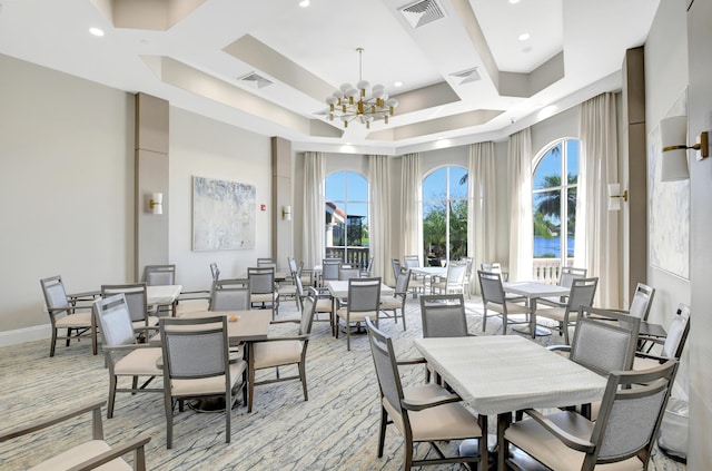 dining area with a notable chandelier, visible vents, and coffered ceiling