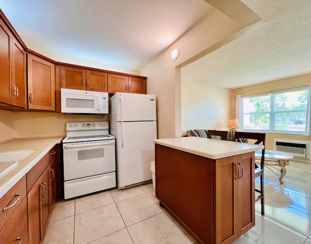 kitchen with brown cabinets, a breakfast bar, a kitchen island, and white appliances