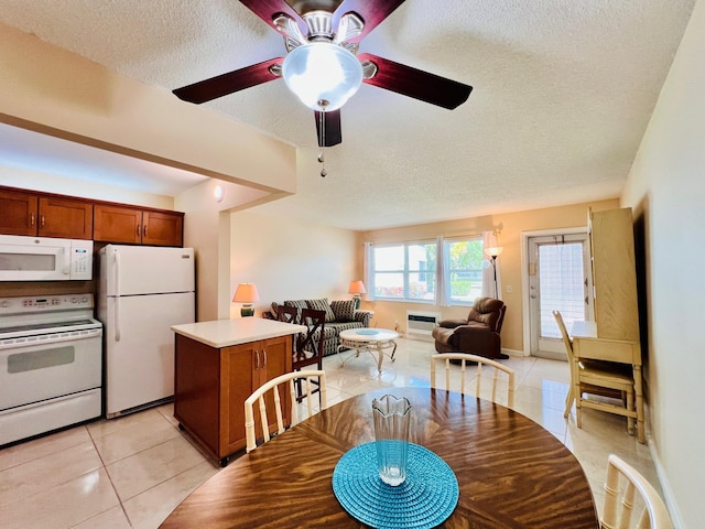 dining space with light tile patterned floors, ceiling fan, and a textured ceiling