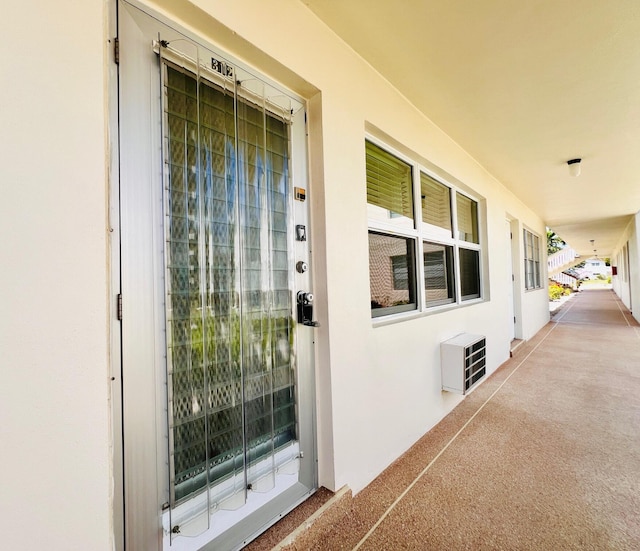 doorway to property featuring stucco siding