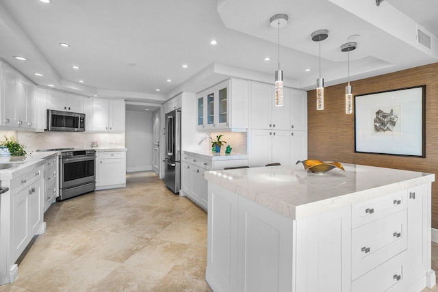 4001 N Ocean Blvd Unit 1108, Boca Raton, FL 33431 - kitchen featuring appliances with stainless steel finishes, white cabinets, recessed lighting, decorative backsplash, and a kitchen island