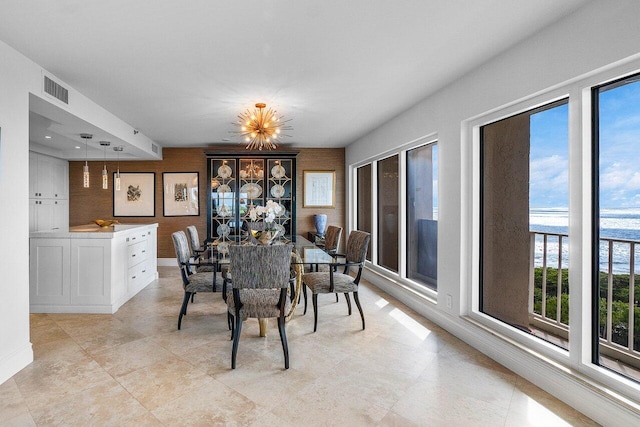 4001 N Ocean Blvd Unit 1108, Boca Raton, FL 33431 - dining room with healthy amount of natural light, baseboards, and a chandelier