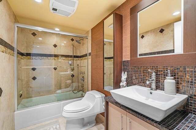 4001 N Ocean Blvd Unit 1108, Boca Raton, FL 33431 - full bathroom with combined bath / shower with glass door, toilet, vanity, tile walls, and recessed lighting