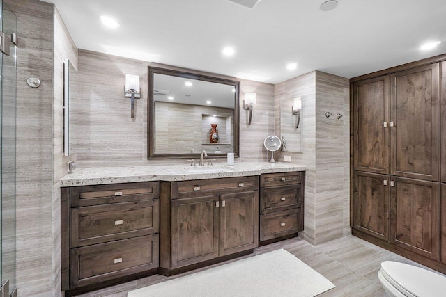 4001 N Ocean Blvd Unit 1108, Boca Raton, FL 33431 - bathroom featuring vanity, toilet, recessed lighting, and tile walls