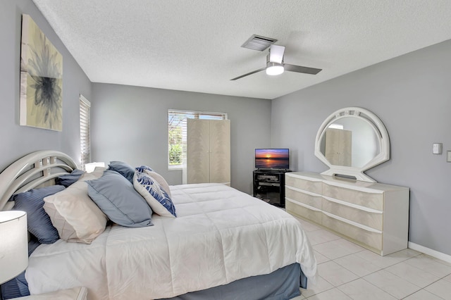 5154 Privet Pl Unit A, Delray Beach, FL 33484 - bedroom featuring a textured ceiling, light tile patterned flooring, and a ceiling fan